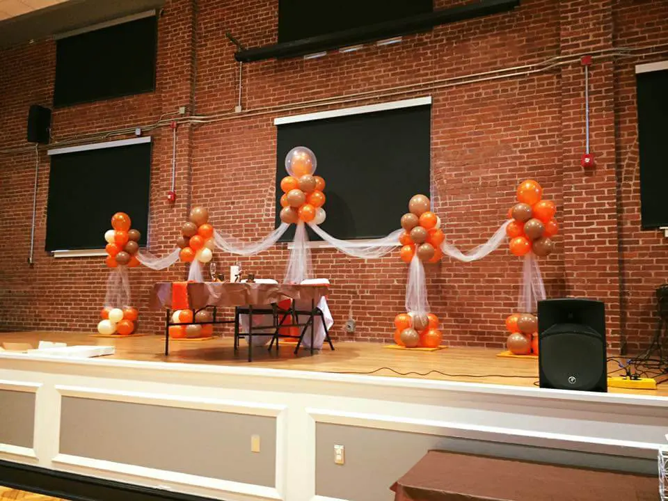 A stunning arch made of Rose Gold, White, Blush, and Orange latex balloons, perfect for adding a festive touch to any occasion in Staten Island delivered by Balloons Lane balloon delivery.