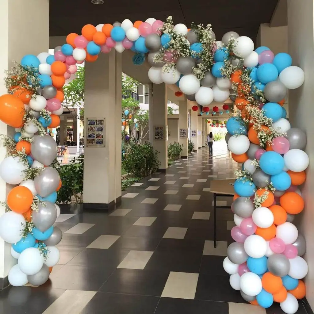 A beautiful garland arch made of Azure, Orange, White, Silver, Pink, and Gray latex balloons, perfect for adding a festive touch to a birthday party in Manhattan, delivered by Balloons Lane Balloon.