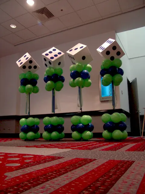 Balloons Lane Balloon in NJ creates a birthday column using dice-shaped balloons in green, navy, and white colors.