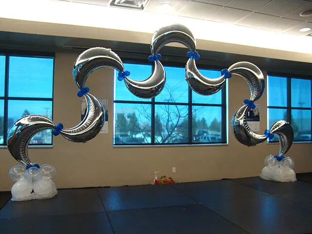 A unique birthday arch featuring Silver Mylar Moon Balloons with a mix of Mini Blue Balloons, perfect for adding a touch of creativity and fun to a birthday celebration in NJ.