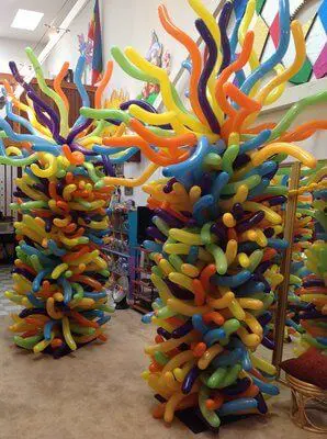 A column of multicolored tube balloons in blue, yellow, purple, pink, orange, and green, delivered by Balloons Lane in NJ for any occasion.