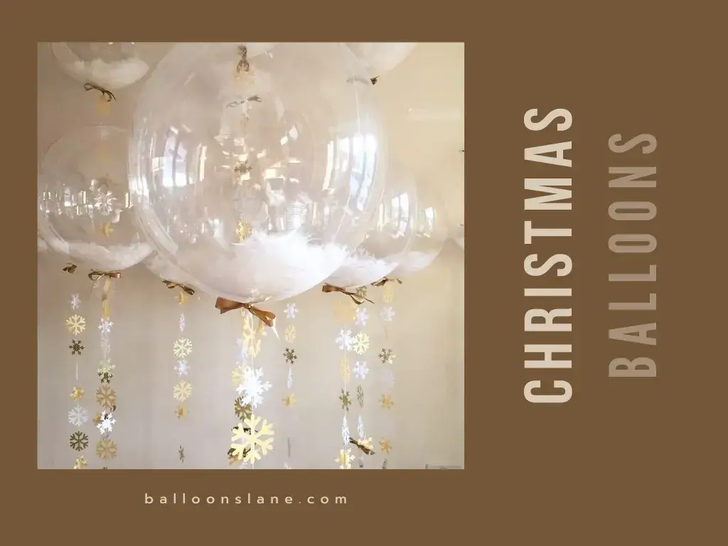 A clear Christmas balloon filled with gold and silver confetti, adorned with gold and silver strings, by Balloons Lane
