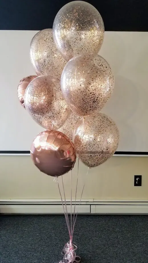 A set of clear and rose gold confetti balloons with a rose gold Mylar balloon, perfect for birthday, anniversary, or christening celebrations in New Jersey.