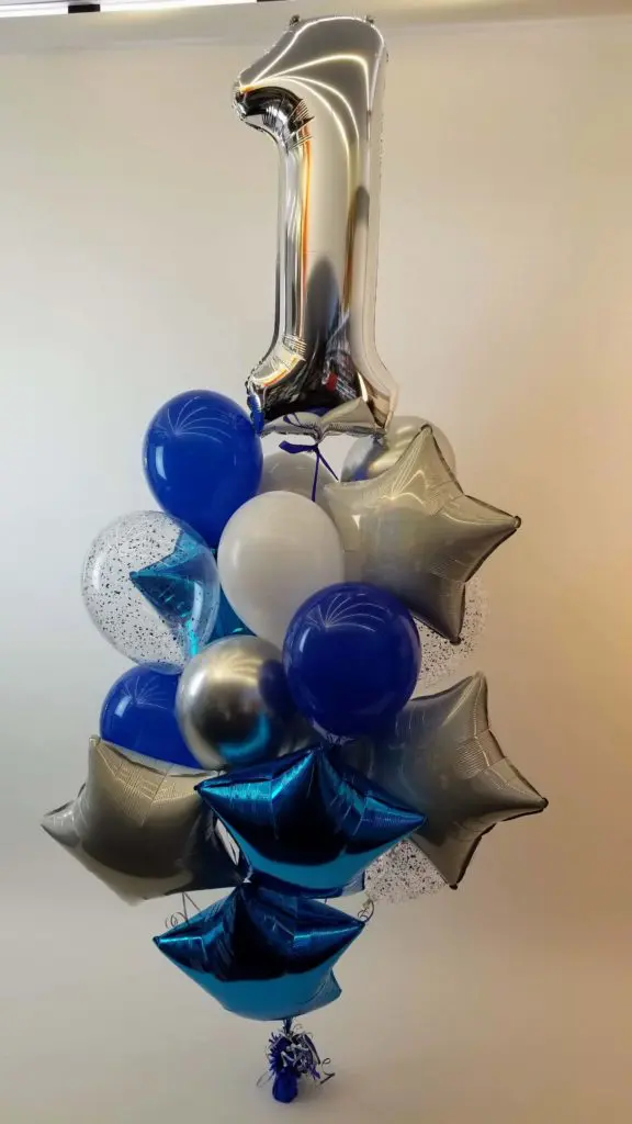 A navy blue, chrome silver, and grey star balloon column with number balloons in blue