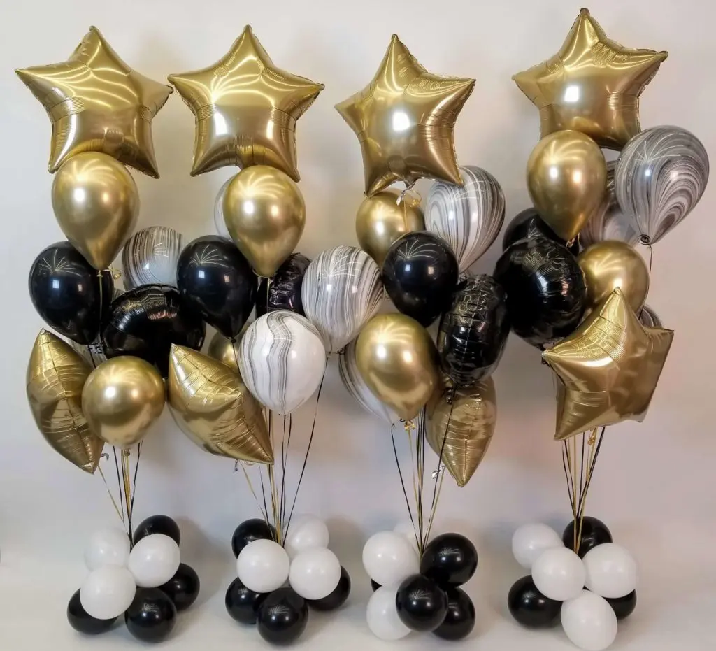 A Chrome Gold Star Balloon Bouquet with White, Black, and Chrome Gold Balloons by Balloons Lane