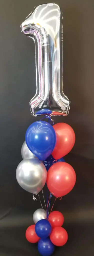 A charming balloon bouquet in silver, blue, and red colors, featuring a silver number 1 balloon, created by Balloons Lane in NYC for a first birthday
