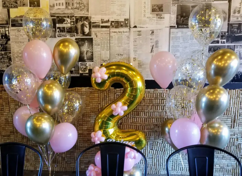 A beautiful balloon bouquet in pink, gold, and chrome silver colors, featuring gold number balloons 2, created by Balloons Lane in New Jersey for a birthday celebration.